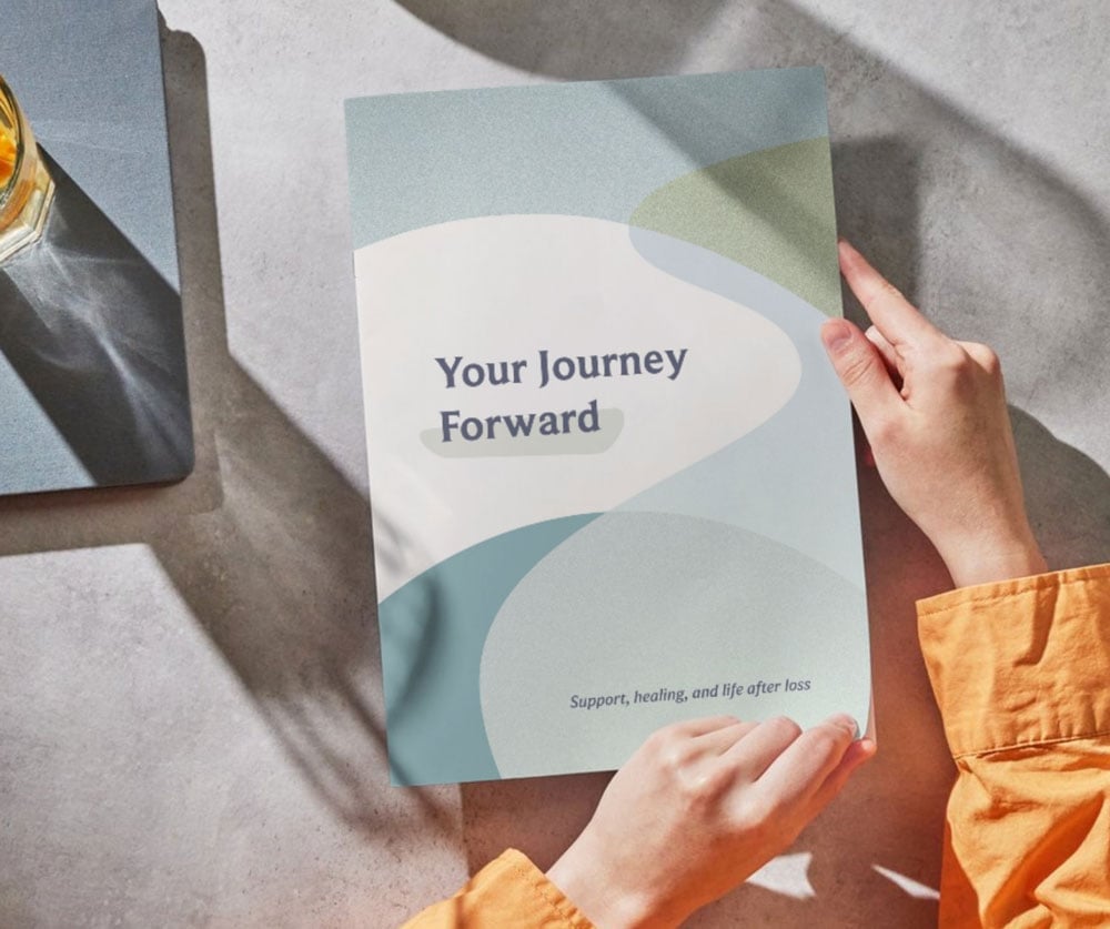 A person reviewing a sample of Your Journey Forward.